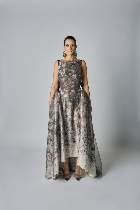 Woman wearing a floral dress against a plain background